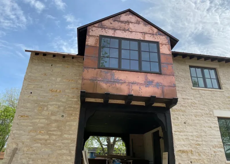 Copper metal panel facade on a stone building for Metal Roof Coating in Webster